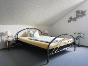 a bedroom with a bed with a metal frame at Ferienwohnungen Blum in Kelberg