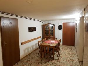 a dining room with a wooden table and chairs at Pension Werner Nagel in Wewelsfleth