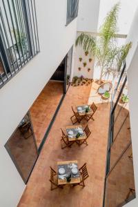 
a dining room table with chairs and a patio at Casa Creativa Lagos in Lagos
