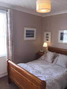 a bedroom with a large bed and a window at Chiverton House Guest Accommodation in Penzance