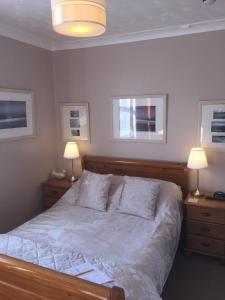 a bedroom with a bed with two night stands and two lamps at Chiverton House Guest Accommodation in Penzance
