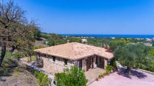 a house on a hill with a view of the ocean at Villa Collina in Vasilikos