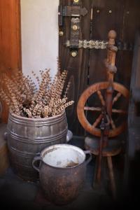 a pot with a plant in it next to a wooden wheel at Agro-zagroda in Strzyżów