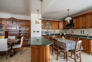 a kitchen with wooden cabinets and a table with chairs at Casale Ceppone in Vico Equense