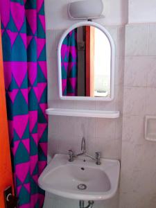 a bathroom with a sink and a mirror at Yanna Studios in Tsilivi