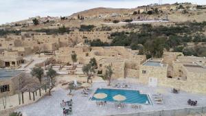 an aerial view of a building with a swimming pool at The Old Village Hotel & Resort in Wadi Musa