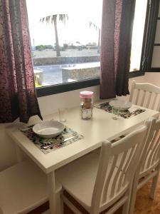 a white table with two chairs and a window at Love Yaiza in Yaiza