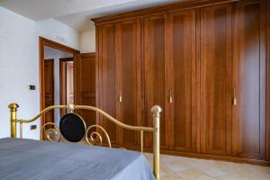 a bedroom with a bed and wooden cabinets at Casale Ceppone in Vico Equense