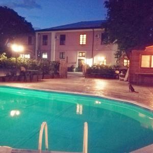 a swimming pool in front of a house at night at Country House Villa delle Rose Agriturismo in Rionero in Vulture