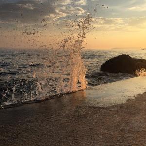 a splash of water on a beach near the ocean at Apartments & Room Paula in Split