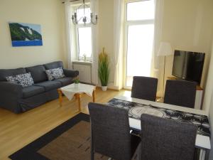 a living room with a table and a couch at Fürstenhof Fewo Beagle in Sassnitz