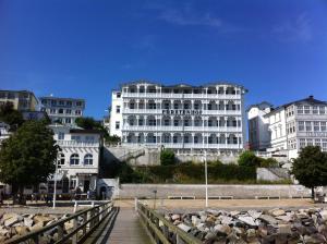 a white building with a bridge in front of it at Fürstenhof Fewo Beagle in Sassnitz