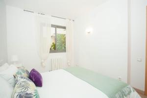 a bedroom with a white bed and a window at Sitges Center & Beach Espalter in Sitges
