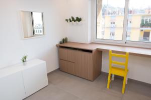 a kitchen with a desk and a yellow chair at Cocor Suites & Design in Naples