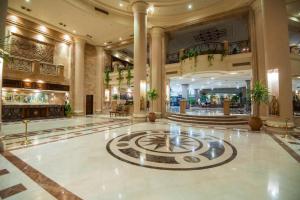 a lobby with a clock in the middle of a building at Shams Safaga Resort in Hurghada