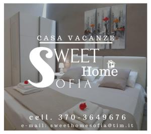 a white bed with a sign that says s sweet home at Sweet Home Sofia in Bologna