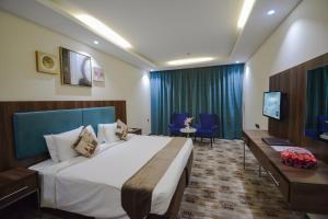 Cama o camas de una habitación en Reef Global Hotel
