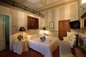 Postel nebo postele na pokoji v ubytování Hotel Villa Beccaris