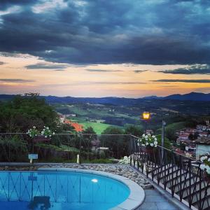 a swimming pool with a view of a city at Hotel Villa Beccaris in Monforte dʼAlba