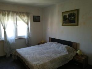 a bedroom with a bed and a window at Guesthouse Porec in Poreč