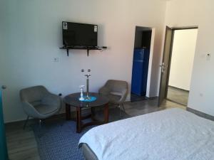 a room with a bed and a table and a tv at Guesthouse Porec in Poreč
