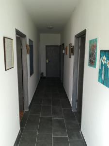a hallway with two doors and a tile floor at Guesthouse Porec in Poreč