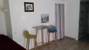 a room with three chairs and a table and a bed at Hotel Marcellin in Beaulieu-sur-Mer