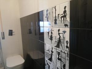 a bathroom with a shower with black and white tiles at Casa America in Montesilvano Marina