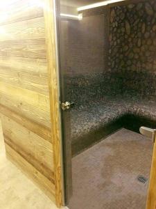a shower with a glass door in a bathroom at Popasul Domnesc- Resort& Spa- Voronet Vue in Voronet