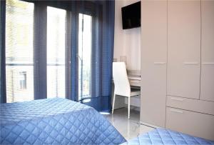 a bedroom with a bed and a desk and a window at La Perla Bianca in Sorrento