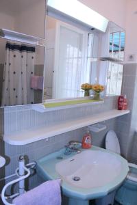 a bathroom with a sink and a mirror at Apartment Arbanasin in Dubrovnik