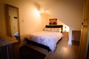 a bedroom with a large bed in a attic at The Old Chemist in Cullen