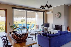 a living room with a blue couch and a table at The Orange Garden in Nafplio