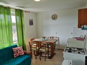 a kitchen with a table and a couch in a room at David in 4 in Primošten