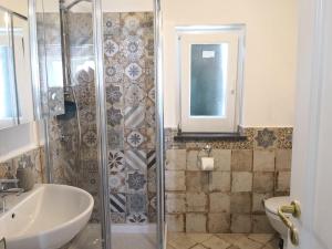 a bathroom with a shower and a sink and a toilet at Il Quadrifoglio in Massa Lubrense +14 photos