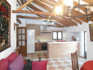 a kitchen with a red couch and a kitchen with at Casa de Los Albas, 6p in Montefrío