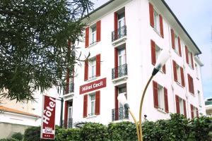 un edificio blanco con un letrero de gol de hotel delante de él en Hôtel Cecil - Boutique hôtel, en Juan-les-Pins