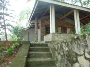a stone house with stairs leading up to it at Green Valley Holiday Resort in Haputale