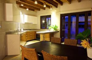 a kitchen with a black table and chairs in it at Villa Sole in Anse Volbert Village +8 photos