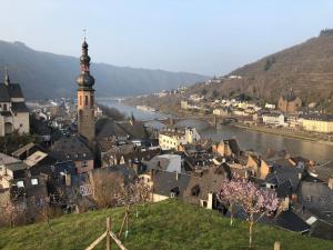 a city with a river and a town with a clock tower at Gästehaus Ziemons in Cochem