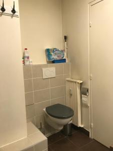 a bathroom with a toilet with a black seat at Appartement T2 - Proche RER in Sartrouville