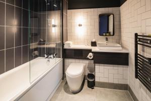 a bathroom with a toilet a sink and a bathtub at Seel Street Hotel by EPIC in Liverpool