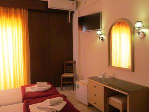 a hotel room with a bed and a sink at Hotel Lito in Paralia Katerinis