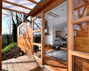 an open door of a tiny house with a porch at Tiny House Dreischwesternherz in Trier