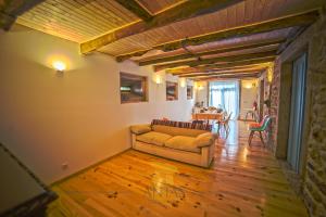 a living room with a couch and a table at Antas Guest House in Esposende