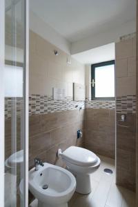 a bathroom with a toilet and a sink at Maurizio e Alessia House in Naples +17 photos