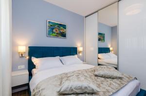 Posteľ alebo postele v izbe v ubytovaní New Art Apartment