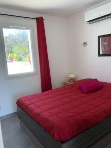 a red bed in a room with a window at Résidence Château Saint Martin in Saint-Martin-dʼArdèche +93 photos