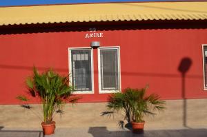 un edificio rosso con piante di fronte di B&B Anirè a Taranto