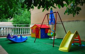 a playground with a slide and a play set at La Noguera in Palomera